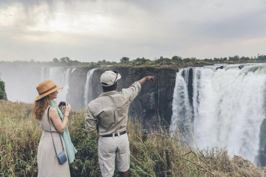 A couple observing a waterfall. 5