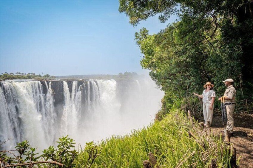 A waterfall with people observing it. 4