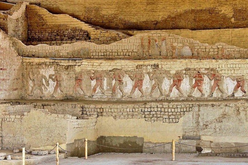 An ancient Egyptian tomb with hieroglyphs and a depiction of a procession. 4