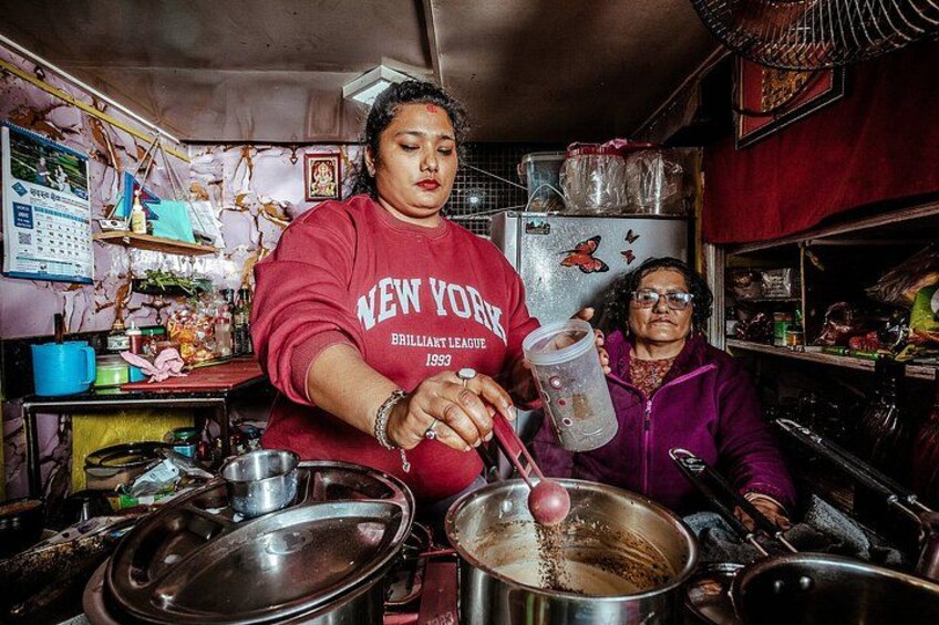 A person cooking in a kitchen with various utensils and containers. 5