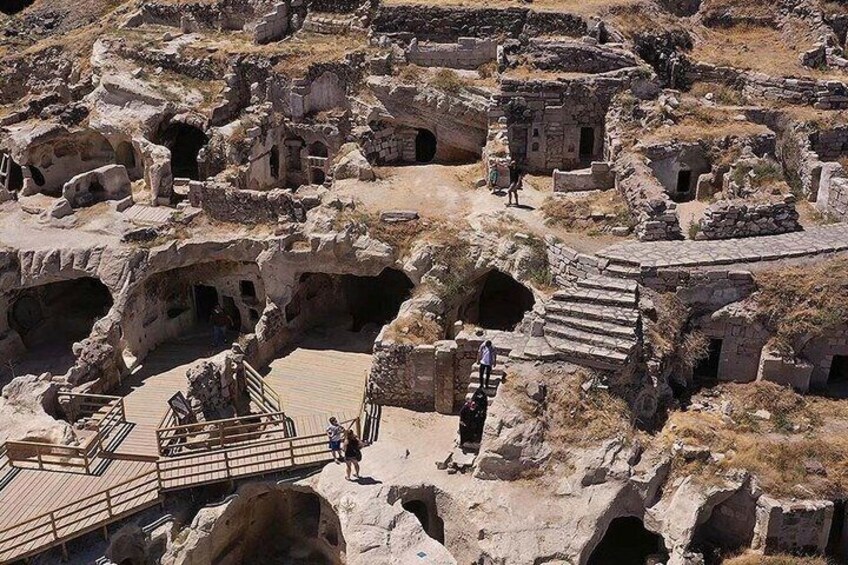 Ancient ruins with multiple structures, including a staircase leading to an elevated area. 3