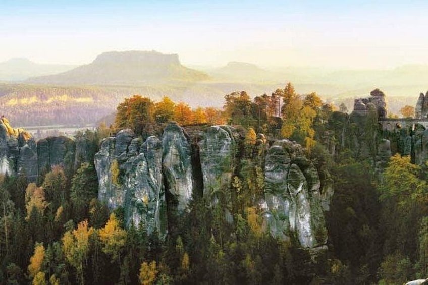 A forested landscape with prominent rock formations. 5