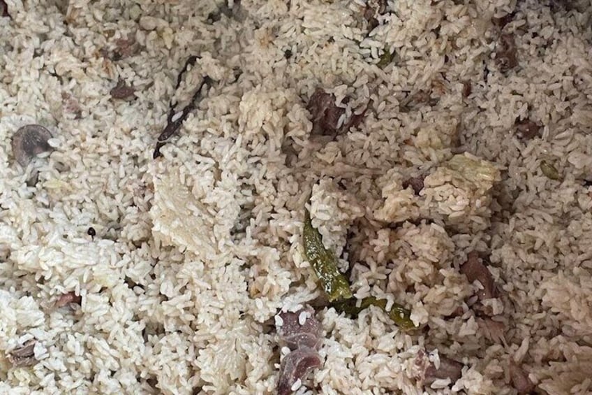 A close-up of a rice dish with visible herbs and spices. 5