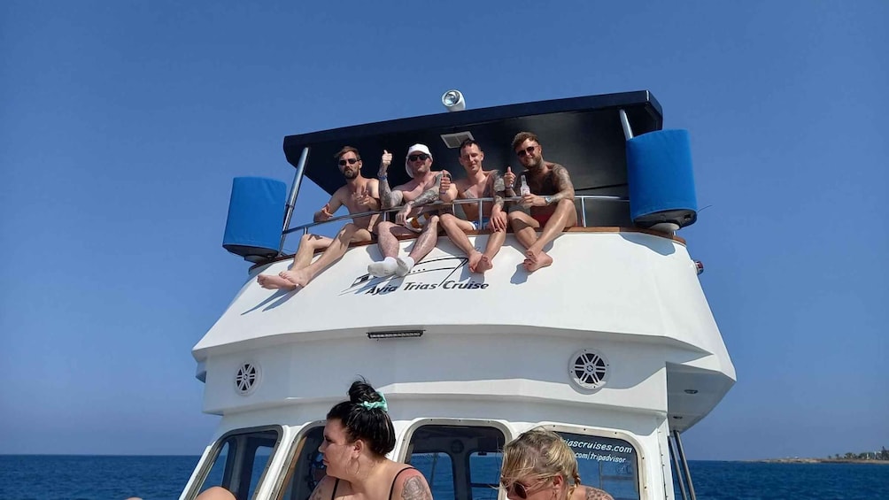 A group of people on a boat with 'Ayla Trias Cruise' written on the side. 2