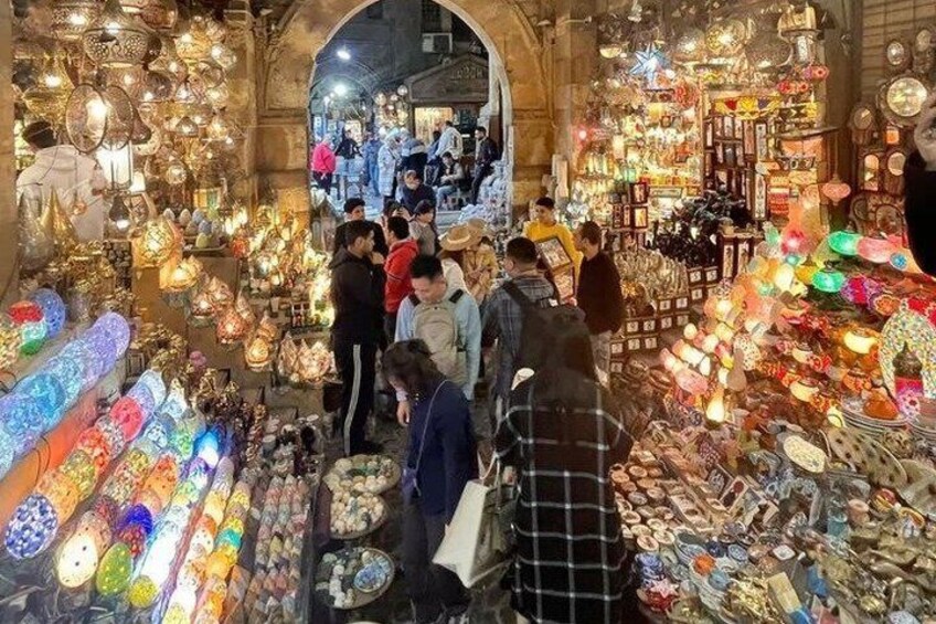A bustling market with stalls selling colorful lanterns and various goods. 1