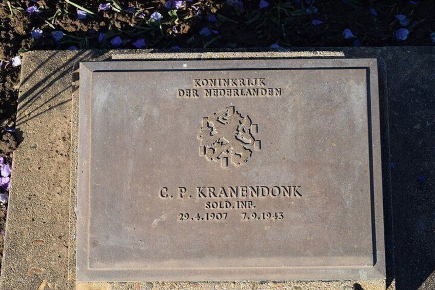 A memorial plaque with text and a map. 1