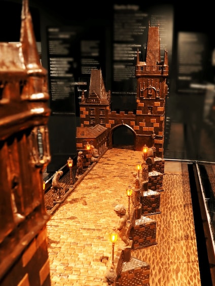 A detailed model of a medieval castle with a drawbridge, brick walls, and a tower. 3