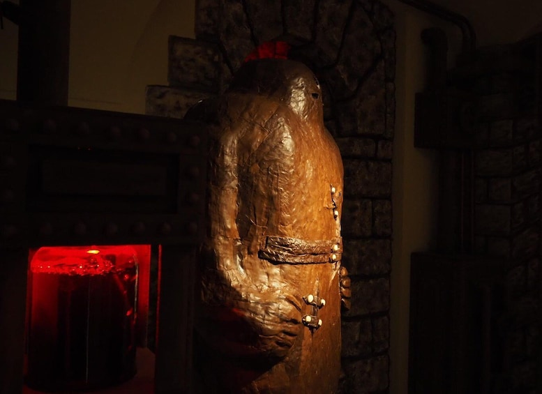 A wooden sculpture with a textured surface and a belt detail. 4
