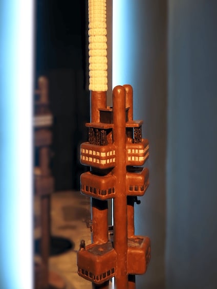 A close-up of a mechanical device with multiple cylindrical components and a textured handle. 1