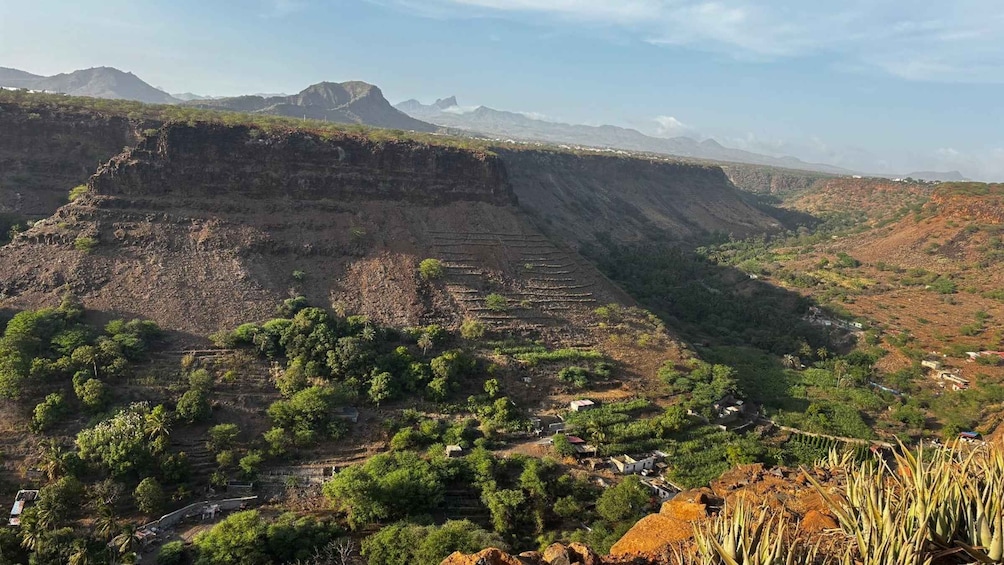 A terraced landscape with a mountain range in the background. 1