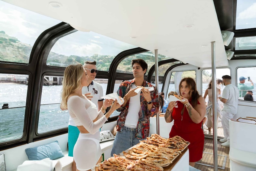 People on a boat eating pizza. 2
