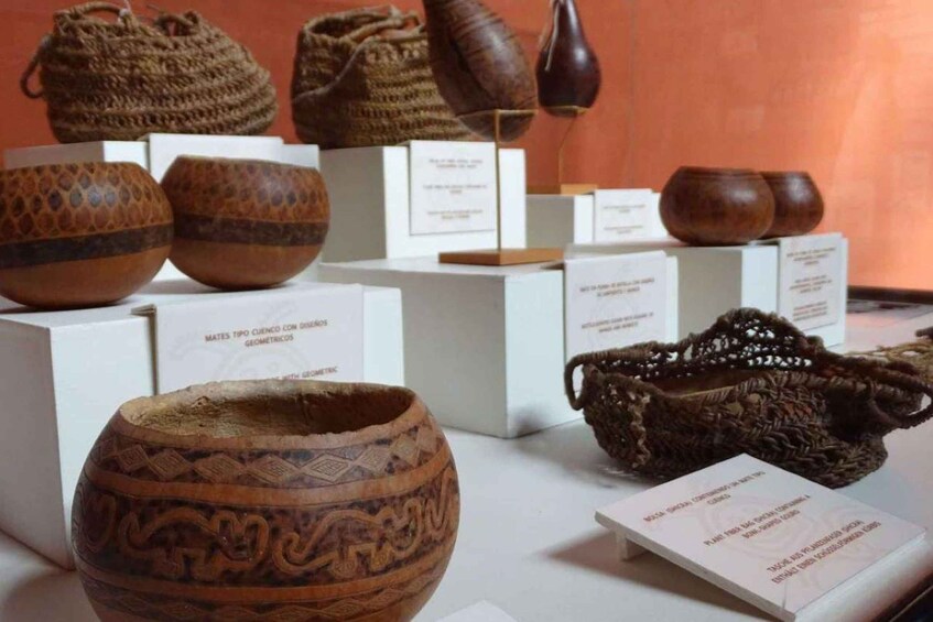 A collection of ancient pottery and woven baskets on display. 3