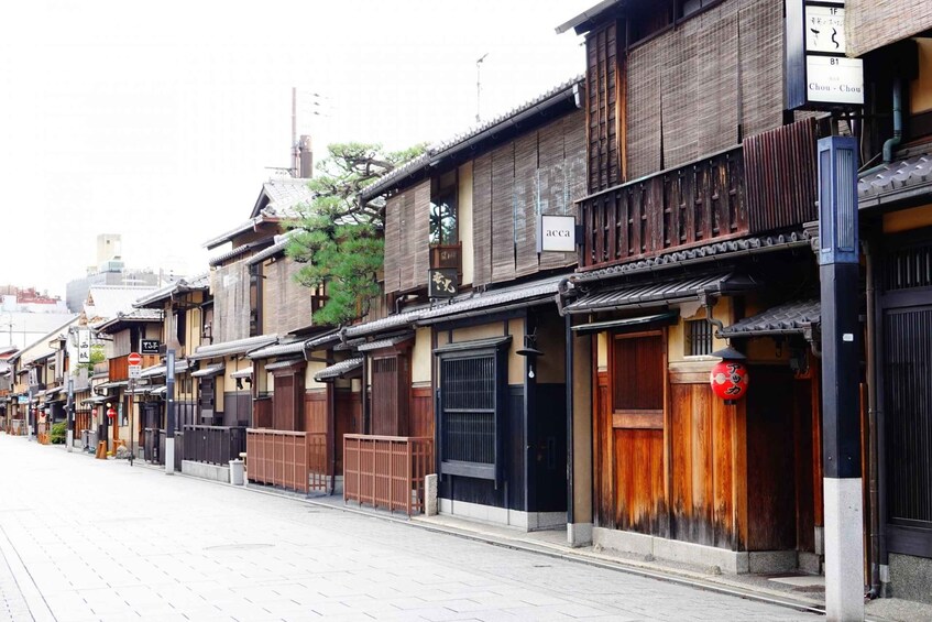 A traditional Japanese street with wooden buildings, a red lantern, and a sign reading 'Chou-Chou.' 2