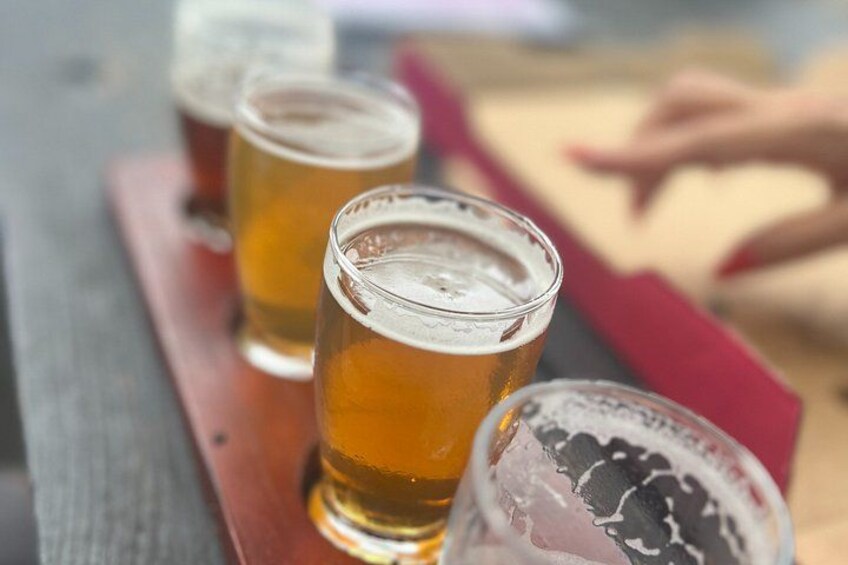 Three glasses of beer on a wooden surface. 1