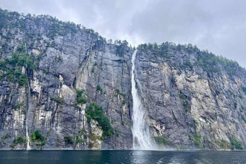 A waterfall cascading down a rocky cliff into a body of water. 4