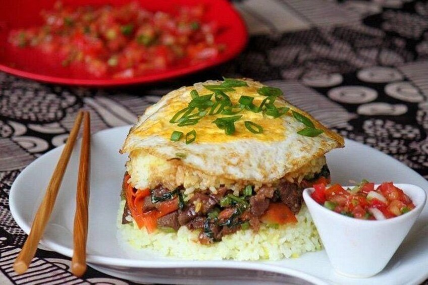 A dish with a fried egg on top, rice, and vegetables. 4