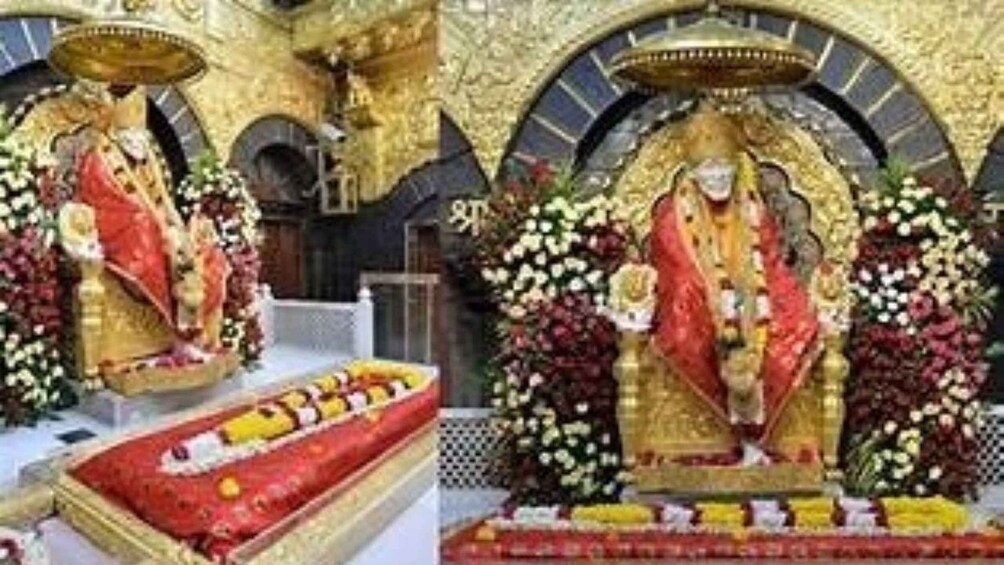 A religious statue with a red and gold robe, surrounded by flowers and an ornate architectural backdrop. 5