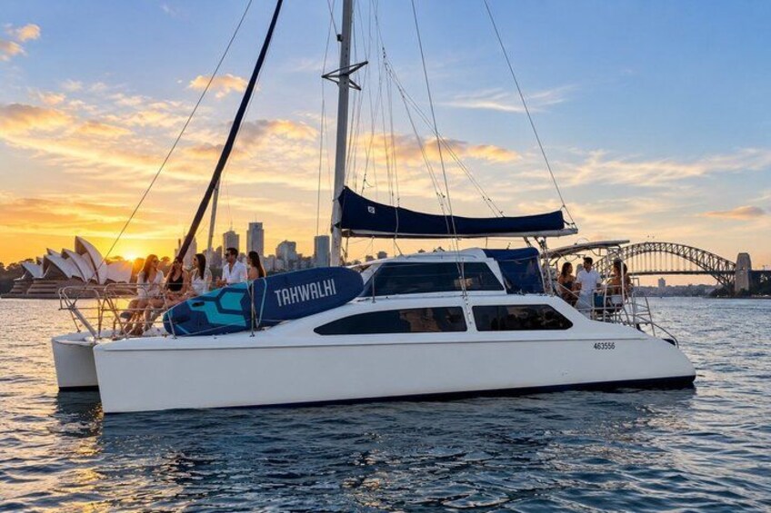 A white yacht named 'TAHWALHI' with a city skyline and Sydney Opera House in the background. 2