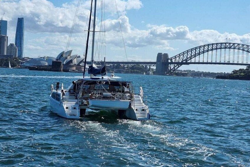 A sailboat on Sydney Harbour with the Sydney Opera House and Harbour Bridge in the background. 1