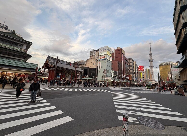 A busy urban intersection with traditional architecture, a prominent tower, and modern buildings. 4