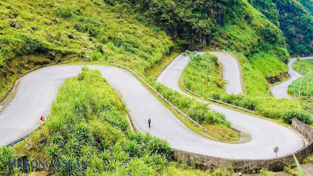 A winding road through lush green hills. 5
