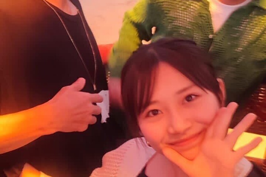 A person in a black top and another in a white top sitting close together. 4