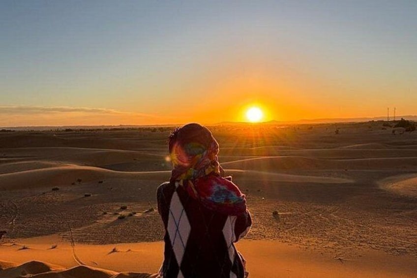 A person in a desert landscape at sunset. 1
