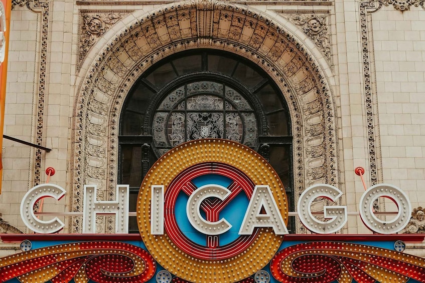 A theater marquee with 'CHICAGO' in large letters and a decorative arch above. 1