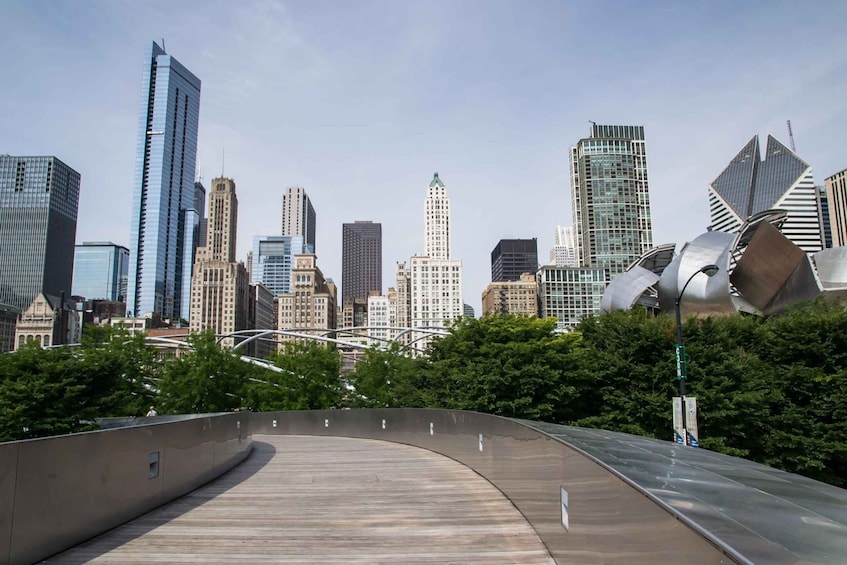 A city skyline with modern skyscrapers and a distinctive metallic sculpture. 3