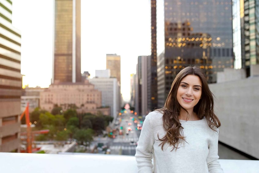 A person standing on a rooftop with a cityscape in the background. 4