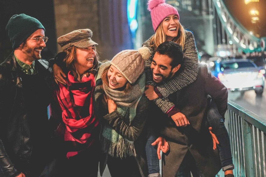 A group of people on a bridge at night. 2