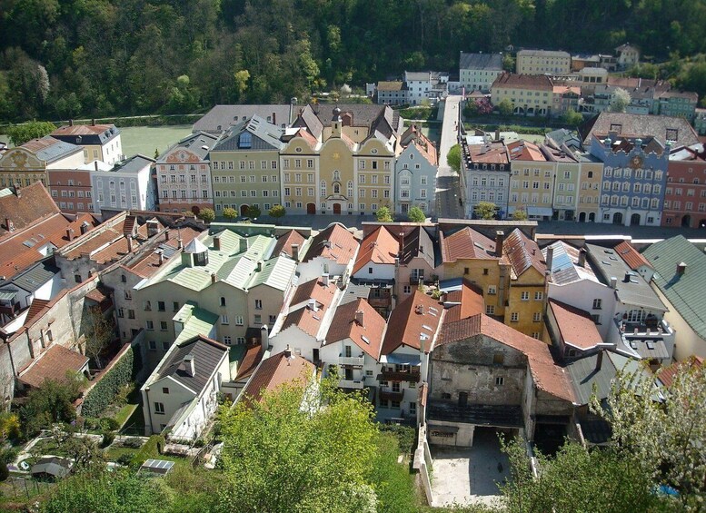 A densely packed urban area with historic buildings, a prominent church tower, and a river in the background. 4