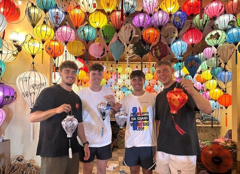 A group of people in a room with colorful lanterns hanging from the ceiling. 2