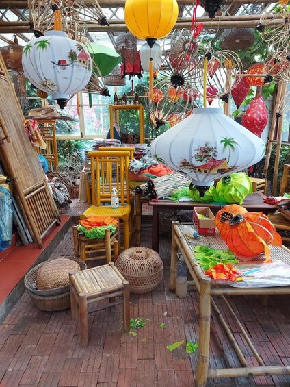 A bamboo structure with various items including lanterns, chairs, and baskets. 5