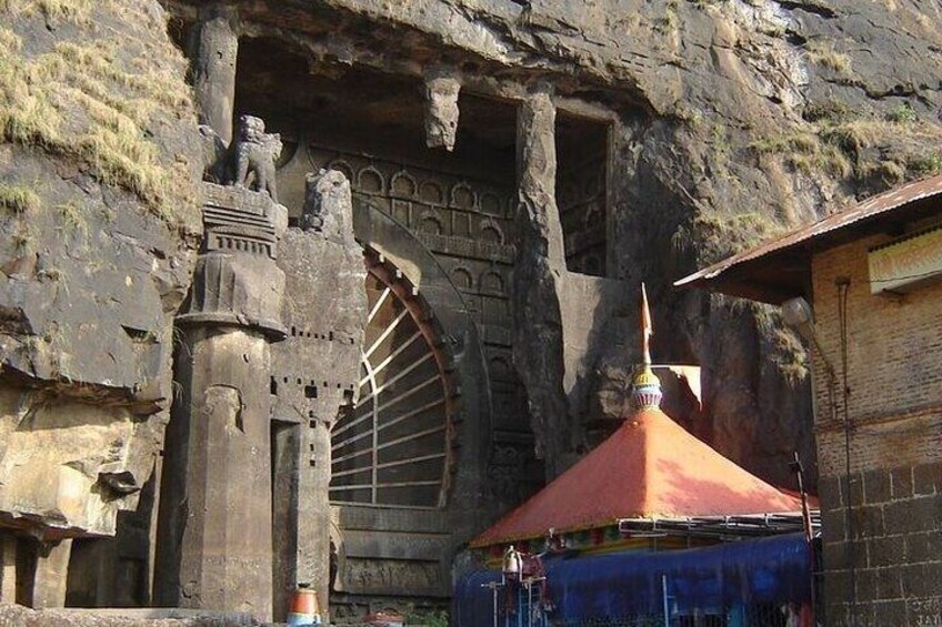 Ancient ruins with a large water wheel and a statue. 5