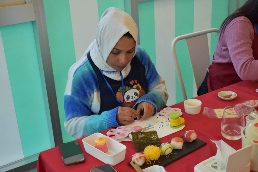 A person sitting at a table with various food items and a smartphone. 4