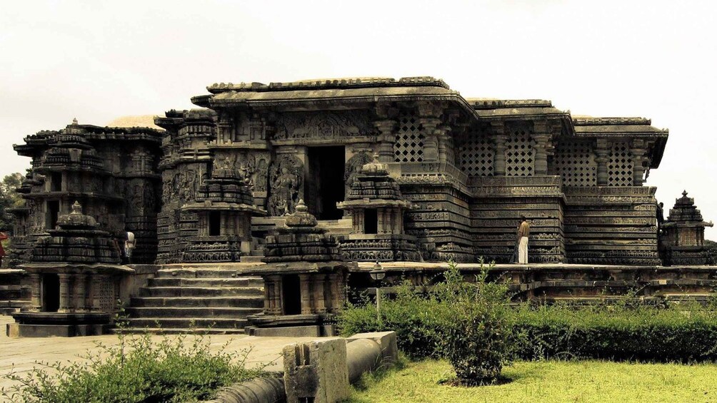 An ancient temple complex with intricate carvings and tiered structures. 5