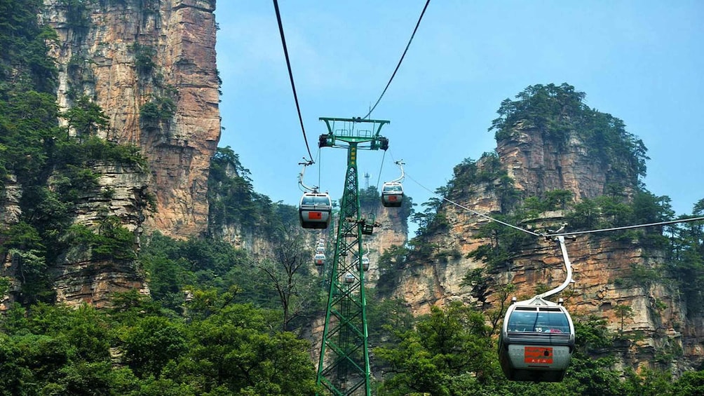 A cable car system with cables and towers amidst a mountainous landscape. 1
