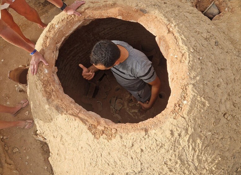 A person inside a large, open, sandy structure. 4