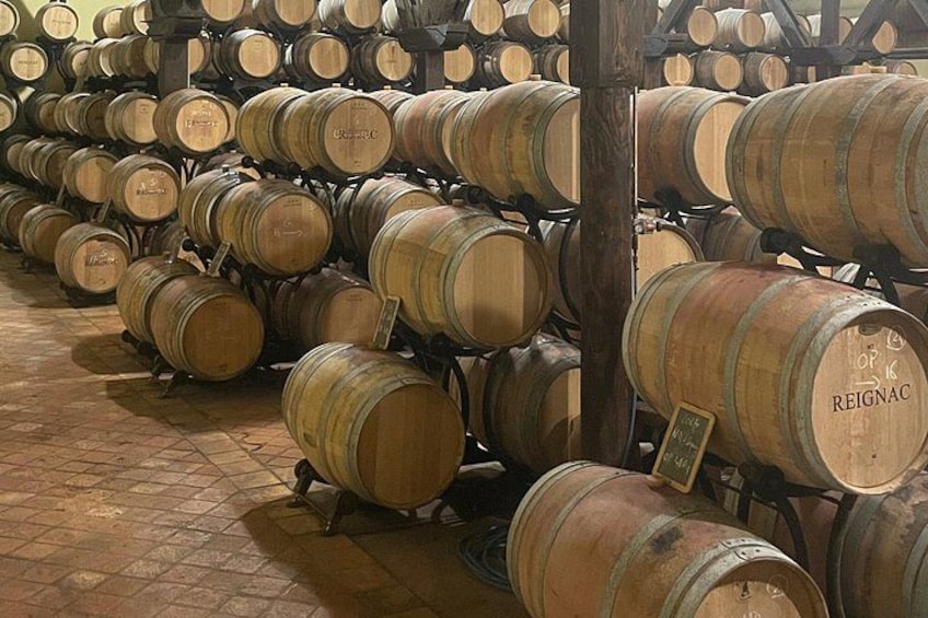 Wooden wine barrels stacked in a warehouse. 5
