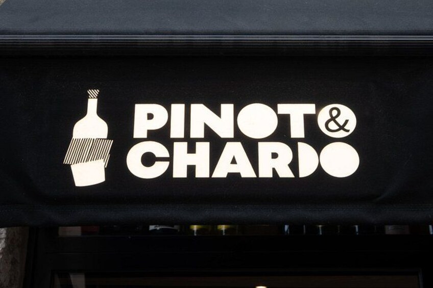A storefront with a sign that reads 'PINOT & CHARDO' and a bottle icon. 2