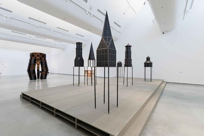 An art installation with geometric structures and a minimalist design in a spacious gallery. 2