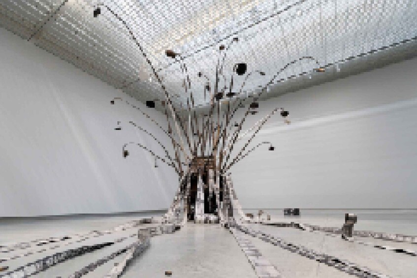 An interior space with a central column, converging lines, and a patterned ceiling. 3