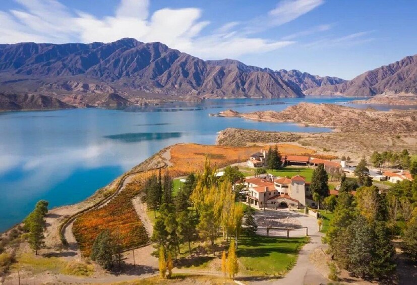 A mountainous landscape with a lake, a residential area with houses, and a clear sky. 5