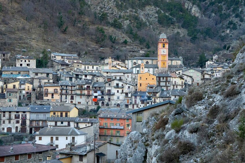 A hillside village with historic buildings and a prominent tower. 2
