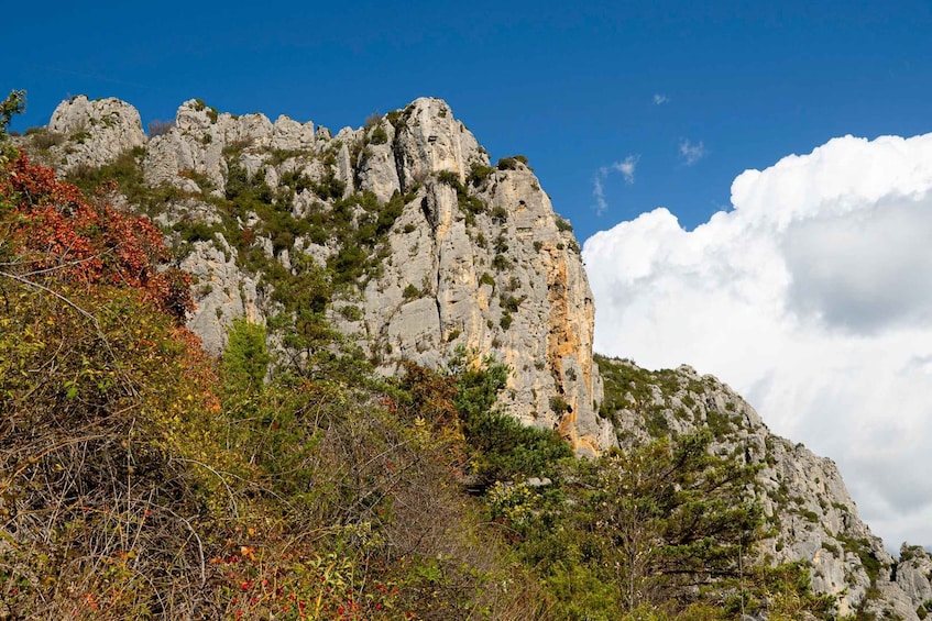 A rugged mountain with rocky cliffs and sparse vegetation. 4