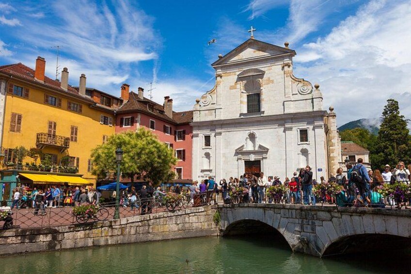 A historic church, a bridge, and a crowd of people. 5
