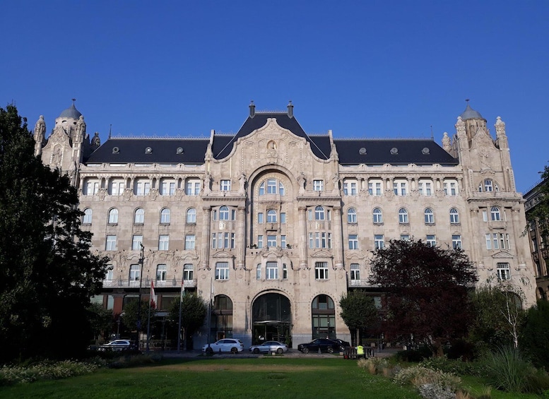 A large, ornate building with a central entrance, multiple windows, and decorative towers. 2