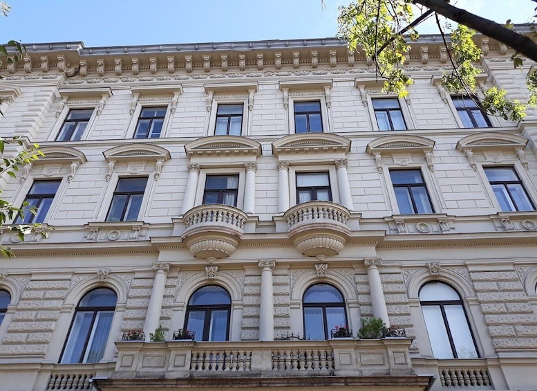A classical building with ornate balconies and arched windows. 5