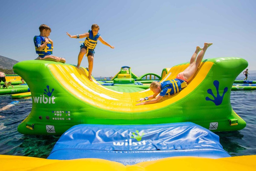 Inflatable water slides and rafts at a beach. 3